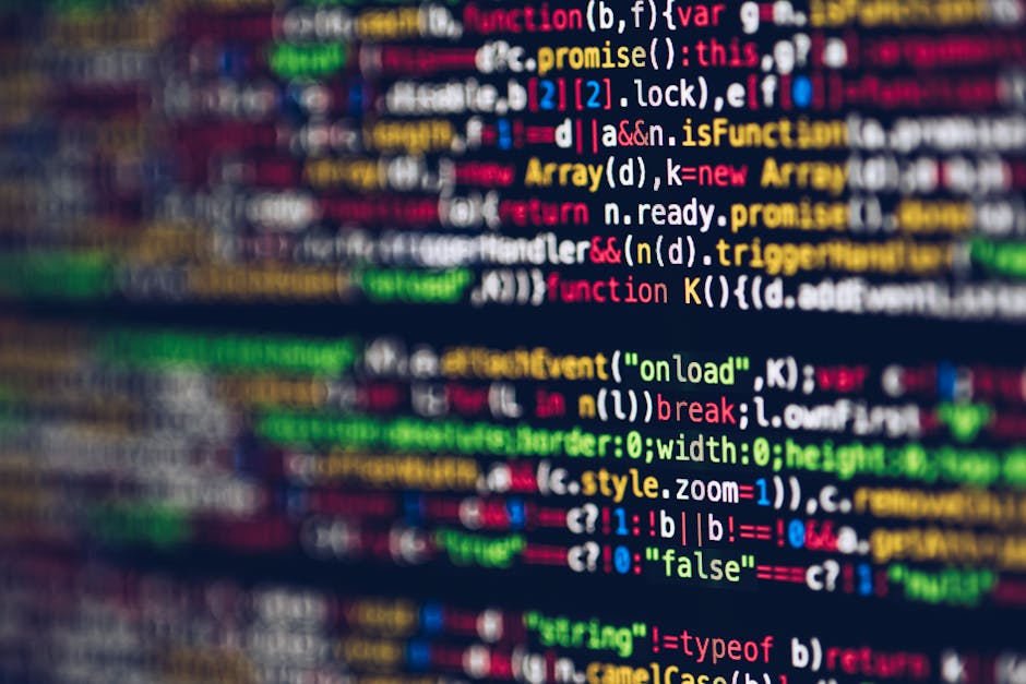 A close-up of a computer screen displaying colorful, blurry lines of code with various syntax highlighting, including keywords, variables, functions, and operators in different colors such as red, gre